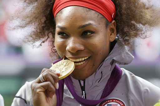 FILE - This Aug. 4, 2012 file photo shows Serena Williams posed with her 2012 Summer Olympics gold medal during the podium ceremony of the women's singles final match at the All England Lawn Tennis Club at Wimbledon, in London. (AP Photo/Elise Amendola, File)